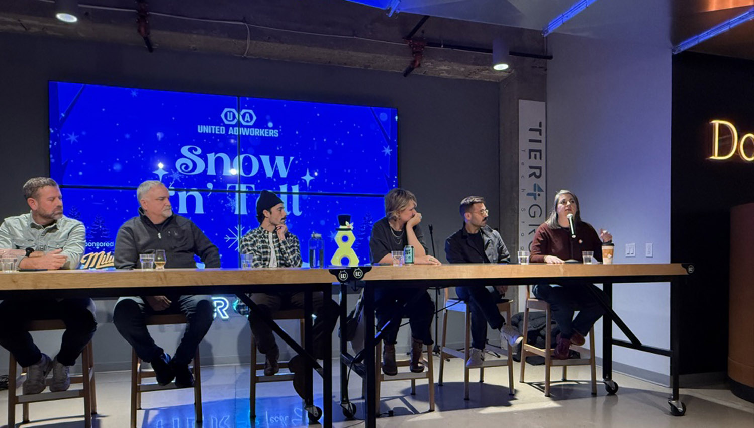 Two Hoffman York employees holding a PR and Comms award.